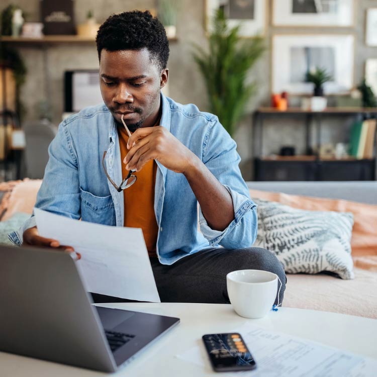 Would a Mastermind Group be Good for Your Business? Man in Home Office Looking at Laptop