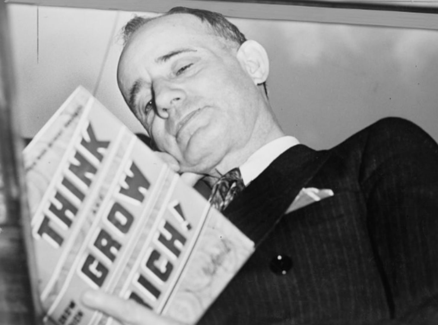 Napoleon Hill, Mastermind group creator, holding his book, 